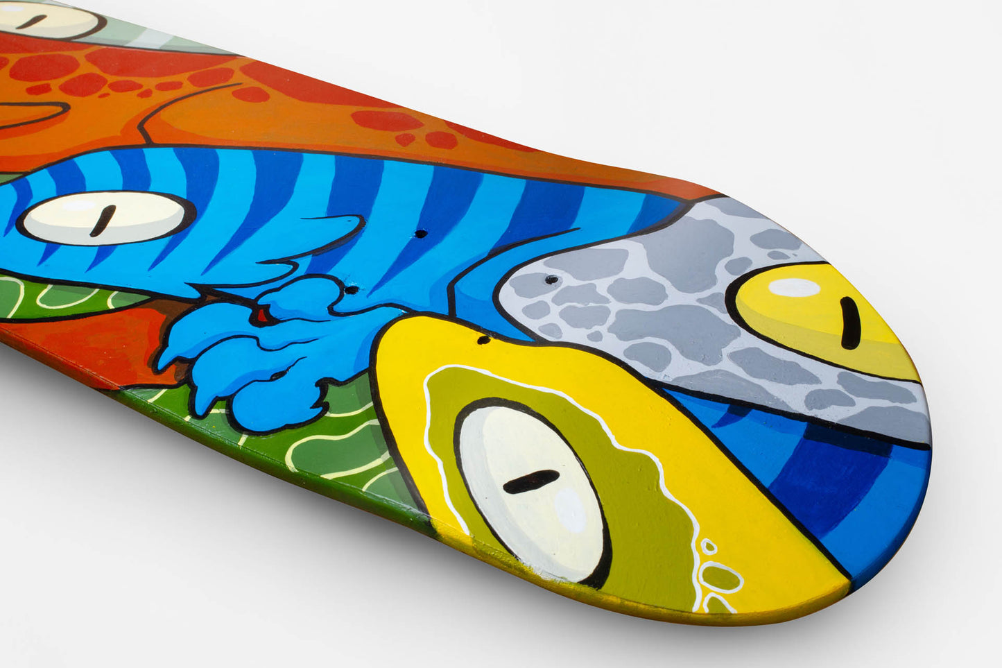 Close-up of the lizards painted on Christian Zeppieri's Skateboard Deck